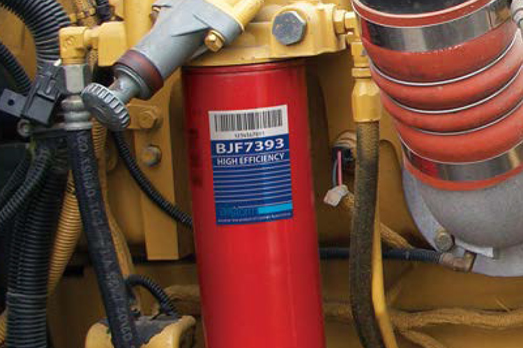 Industrial Label Engine Decal example on red tube on mechanical machinery